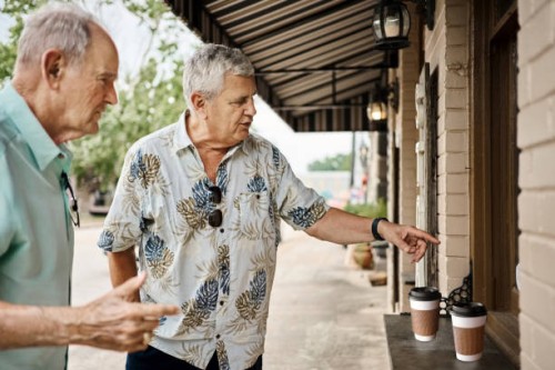 two senior men ordering coffee at restaurant window - junk food stock pictures, royalty-free photos & images