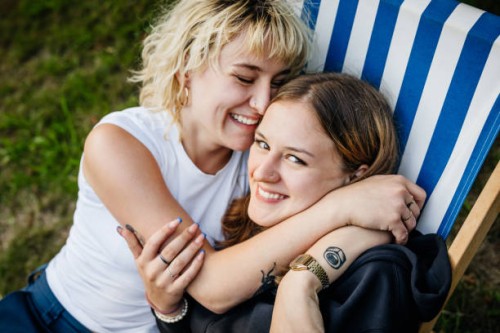 two sisters relax in deck chair in their garden - garden decoration photos et images de collection