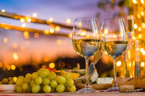 two white wine glasses on outdoors restaurant table - food stock pictures, royalty-free photos & images