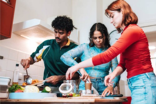 two young woman and young men preparing fresh food for take away - junk food stock pictures, royalty-free photos & images