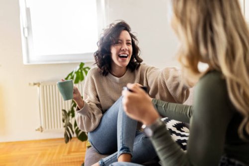 two young women having coffee and chatting having great time - coffee stock pictures, royalty-free photos & images