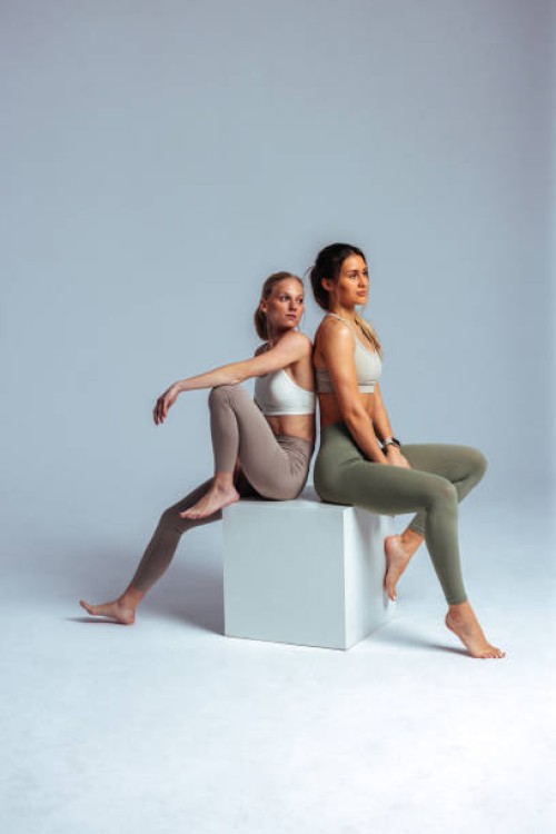 two young women relaxing after fitness training session - fashion stock pictures, royalty-free photos & images