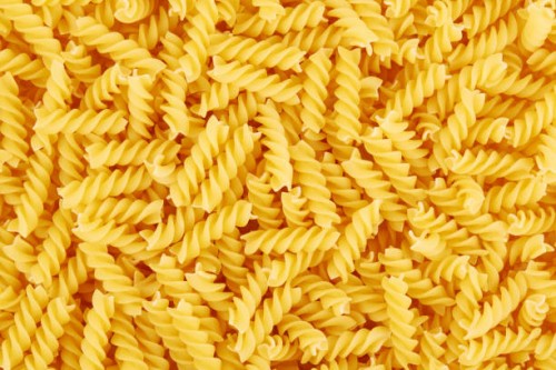 uncooked fusilli pasta background - food stock pictures, royalty-free photos & images