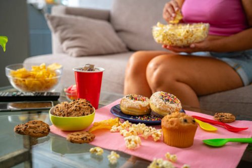 unhealthy eating concept. unrecognizable woman unhealthy eating - junk food stock pictures, royalty-free photos & images