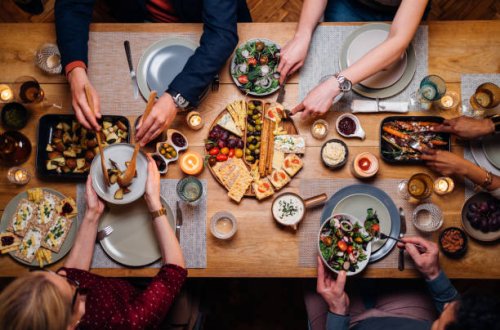 unrecognizable friends and family sharing food at dinning room - food stock pictures, royalty-free photos & images