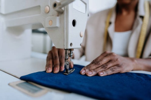 unrecognizable person sewing using sewing machine - fashion stock pictures, royalty-free photos & images