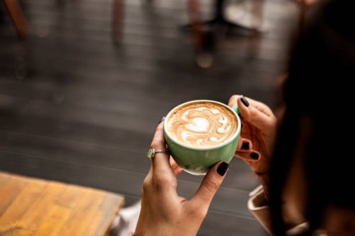 unrecognizable woman having a cup of coffee - coffee stockfoto's en -beelden