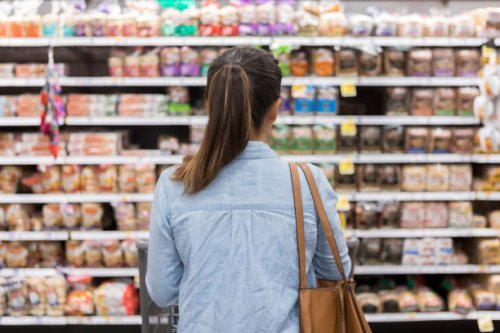 unrecognizable woman marvels at grocery bread selection - food stock pictures, royalty-free photos & images