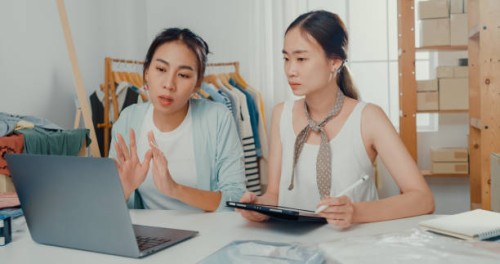 upset young asian women with laptop and tablet meeting check stock prepare order and plan shipping to customer at shop. - fashion stock pictures, royalty-free photos & images