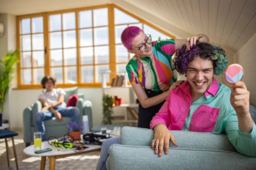 urban young woman with pink hair curling her male friend hair - fashion stock pictures, royalty-free photos & images