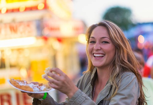 usa, maine, rockland, woman eating funnel cake at funfair - food stock pictures, royalty-free photos & images