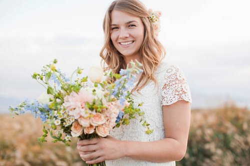 usa, utah, provo, portrait of bride holding bunch of flowers - hairstyle stock pictures, royalty-free photos & images