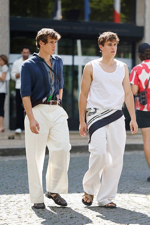 Valen Volinetts and Vova Volinetts wear white top, white trousers, taupe sandals, white and blue scarf on the waist , and blue sweater shorts sleeves...