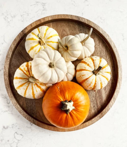 variety of pumpkins on a wooden tray on white, marble background - home decoration stock pictures, royalty-free photos & images
