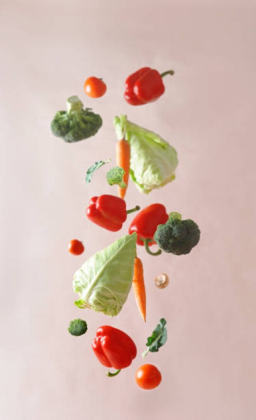 various colorful vegetables falling at pale beige background - food stock pictures, royalty-free photos & images