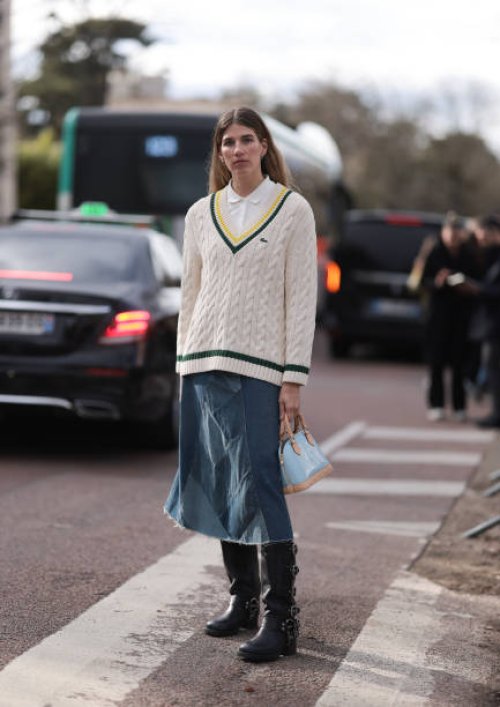 Veronika Heilbrunner seen wearing cream and black Lacoste sweater, white shirt, blue denim jeans skirt and black boots with tan and light blue bag...