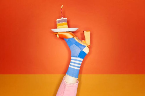 vibrant foot balancing slice of birthday cake - food stock pictures, royalty-free photos & images