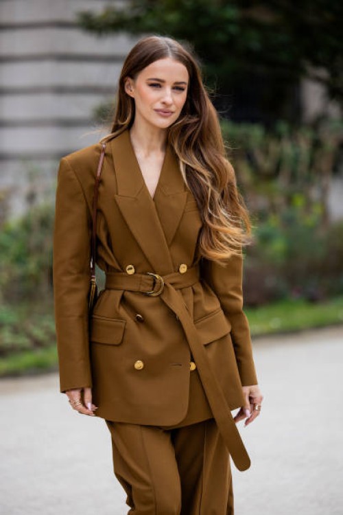 Victoria Magrath wears brown belted blazer, matching pants, bag outside Zimmermann during the Womenswear Fall/Winter 2025/2026 as part of Paris...