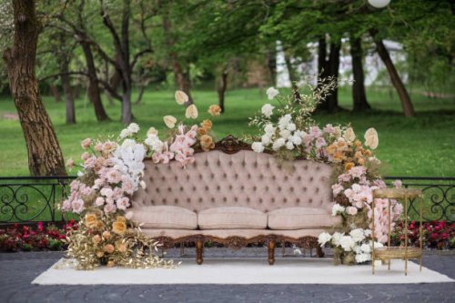 view of a sofa decorated with flowers with park on the background. - garden decoration stock pictures, royalty-free photos & images