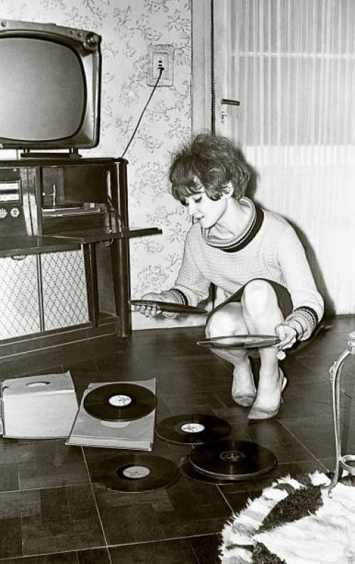 vintage photo of a young woman looking at vinyl records - fashion stock pictures, royalty-free photos & images