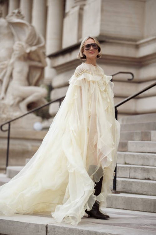 Violet Grace wears pale yellow ruffled dress, boots, sunglasses outside the Zimmermann fashion show during the Womenswear Fall/Winter 2025/2026 as...