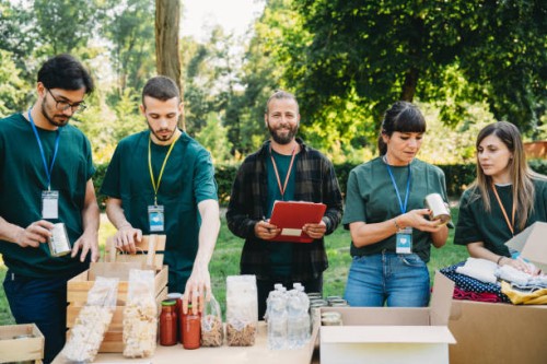 volunteers teamwork are working together in a food and clothes bank - food stock pictures, royalty-free photos & images