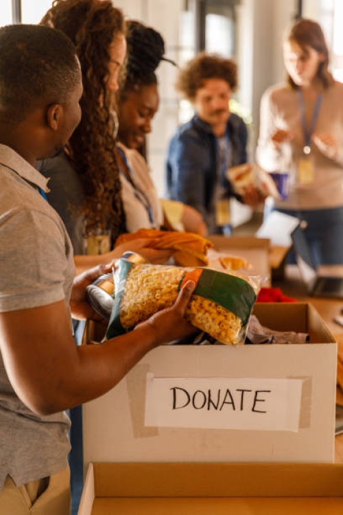 volunteers working together to organize boxes with donations - food stock pictures, royalty-free photos & images