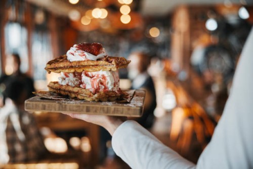 waffles, ice cream and dessert in hand, fast food restaurant service with person and sweet treat for customer. catering, hospitality and cuisine with dairy treat on wooden plate, luxury and delicious - junk food stock picture