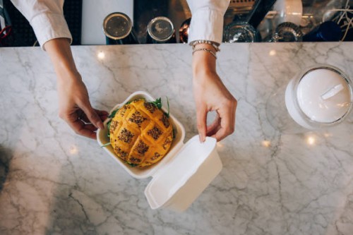 waiter preparing a take out burger - junk food stock pictures, royalty-free photos & images