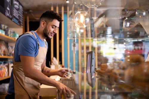 waiter working at a cafe preparing a delivery order - junk food stock pictures, royalty-free photos & images