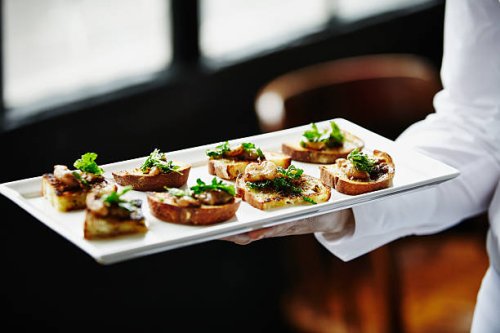waitress holding platter of organic appetizers - food stock pictures, royalty-free photos & images