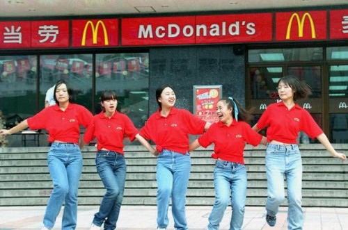 Waitresses from the US fastfood giant McDonald's dance outside an outlet in Beijing 03 October 2000 to attract more customers during festivities to...