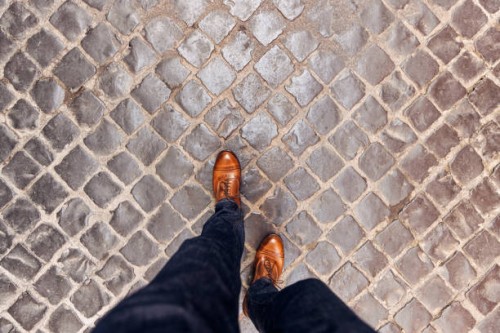 walking on cobblestone street wearing leather shoes in rome, directly above personal perspective view - fashion stock pictures, royalty-free photos & images
