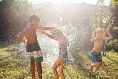 water bomb ballong fight on a hot summer day - garden decoration stock pictures, royalty-free photos & images