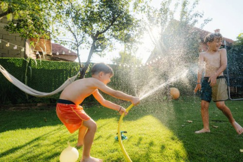 water fight in our yard - garden decoration stock pictures, royalty-free photos & images