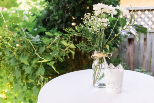 wedding reception decor, tables with white linens, vintage glassware, baby's-breath, lace and twine. - garden decoration stock pictures, royalty-free photos & images