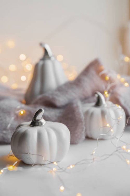 white decor pumpkin on windowsill on background of textured light sweaters in defocus - home decoration stock pictures, royalty-free photos & images