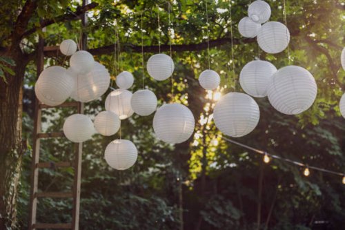 white paper lanterns hanging in trees in the garden. decoration service. garden party, summer festival, wedding. - garden decoration stock pictures, royalty-free photos & images