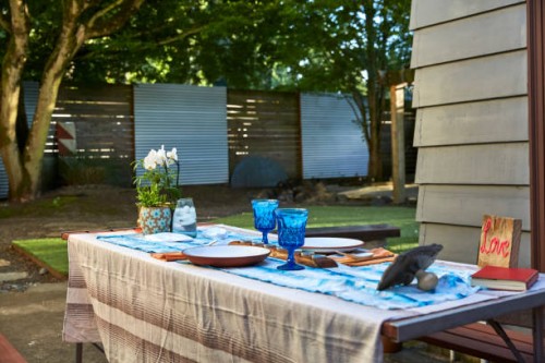 wide shot of a table set up for dinner in a back yard at sunset. - garden decoration stock pictures, royalty-free photos & images