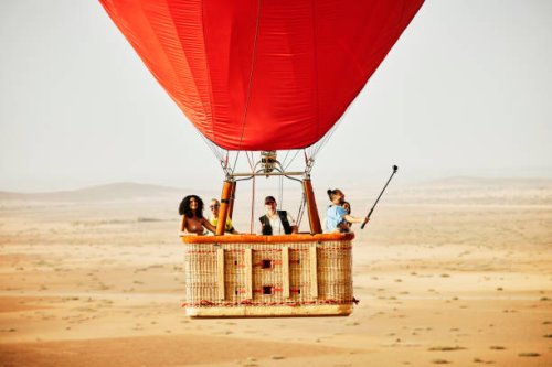 wide shot of family and friends on early morning hot air balloon ride - travel stock pictures, royalty-free photos & images