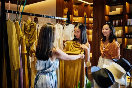 wide shot of mother and daughters shopping for clothes in boutique - fashion stock pictures, royalty-free photos & images