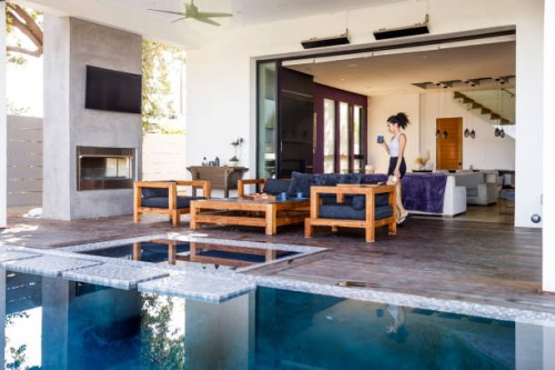 wide shot of woman relaxing in vacation rental - home decoration stock pictures, royalty-free photos & images