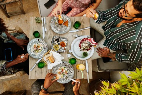 wide shot overhead view of friends sharing dinner at rooftop restaurant - food stock pictures, royalty-free photos & images