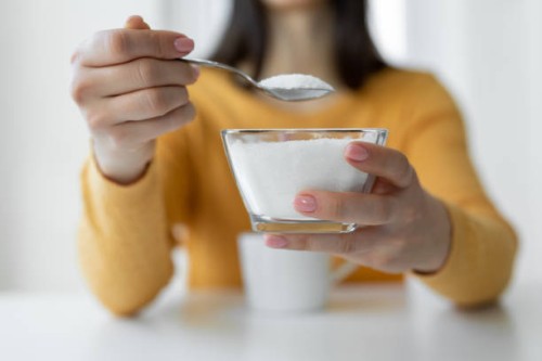 woman adding refined sugar to cup of coffee - food stock pictures, royalty-free photos & images