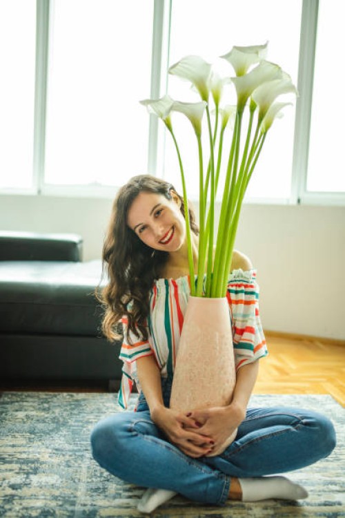 woman arranging calle in vase - home decoration stock pictures, royalty-free photos & images