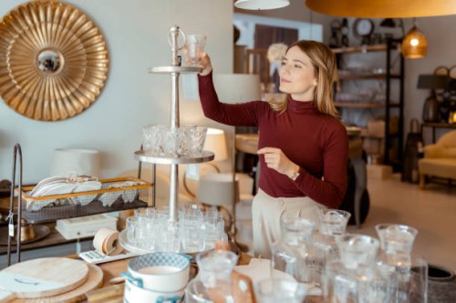 woman arranging home accessories in home decor store - home decoration stock pictures, royalty-free photos & images