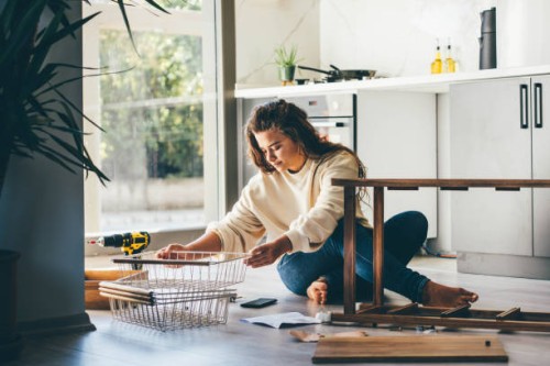 woman assembling furniture at home. - home decoration stock pictures, royalty-free photos & images