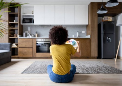 woman at home choosing a color to paint the walls - home decoration stock pictures, royalty-free photos & images