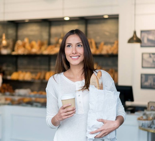 woman buying bread at the bakery - junk food stock pictures, royalty-free photos & images