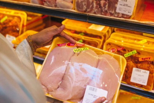 woman buying halal meat in a supermarket - food stock pictures, royalty-free photos & images